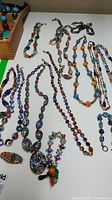Overview of all necklaces and bracelets laid out on white surface
