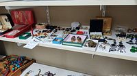 Wide view of shelf displaying trays with assorted earrings, necklaces and bracelets