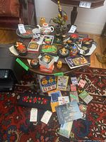 Wide shot of table with assorted Soviet era collectibles including trinket boxes, nesting dolls, porcelain, figurines and books