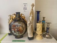 Lot arranged on shelf showing vase, figurines and candle holders