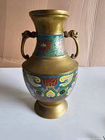 Full view of the antique brass cloisonné vase showing its shape, handles, and colorful enamel inlays