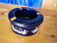 Top view of antique Italian ceramic ashtray showing deep blue cobalt glaze and three cigarette rests with some wear.