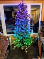 Tree assembled indoors, lit with multi-color LED lights showing gradient effect