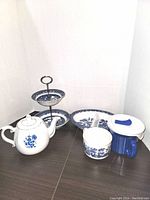 Full view of the complete set showing all items including two-tiered serving dish, teapot, pickle dish, CorningWare soup cup with lid and venting cap, smaller soup cup, and large oval platter.