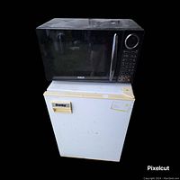 Photo of RCA microwave and Danby mini refrigerator stacked