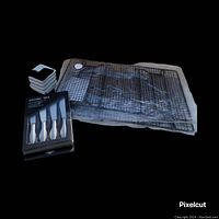 Photo showing two metal baking cooling racks, set of 4 small white ceramic stackable dishes, and boxed set of 4 stainless steel spreaders.