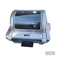 Front view of the stainless steel Ronco EZ-Store rotisserie oven with glass window and digital control panel visible.