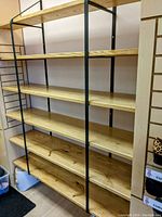 Assembled shelving unit showing six shelves mounted on two ladder-style brackets