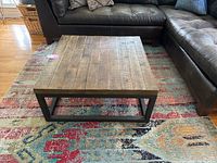 Coffee table top and metal frame base from angled frontal view