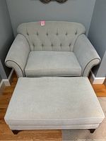 Front view of loveseat and ottoman displaying overall appearance and condition