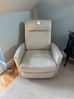 Front view of recliner in upright position showing seat, arms, back upholstery