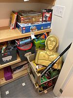 Shelf overview showing boxed sets on upper shelf and tubs with loose items below