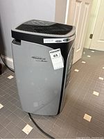 Front side view of the grey and black Soleus Air dehumidifier showing the brand label and overall condition.