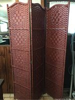 Full view of the three connected wicker privacy screen panels showing size and overall structure.