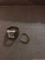 Both rings on dark fabric, overview of lot.