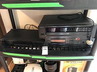 Three Kenwood audio components stacked on a shelf: KT-88 tuner on top, DP-7090 CD player with cassette deck in middle, KA-570 integrated amplifier at bottom.