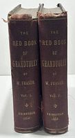 Photo of spines of two volumes showing gilt lettering and year 1868.