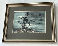 Framed watercolour painting depicting the landscape titled "Evening Georgian Bay" with a prominent windswept tree and moody sky.