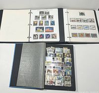 Three binders containing a variety of mounted and loose Great Britain stamps shown on black album pages and under protective sheets.