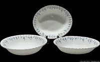 Three-piece set with two oval vegetable dishes and one round salad bowl, all showing blue floral pattern with gold trim on white china.