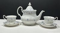 Full set view showing teapot, two cups and two saucers