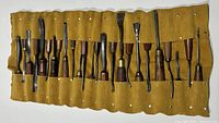 26 chisels rolled out in yellow suede pouch