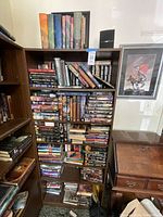 Full shelf view showing five levels of books and adjacent furniture.