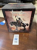 Front view of the boxed Darkhours Death Dealer miniature statue with artwork of the statue on the box.