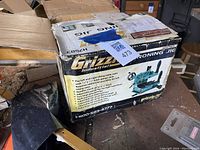 Box with product image and some feature details visible, showing worn packaging and original box.