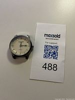 Front view of Longines men's quartz watch case on white background next to MaxSold lot card 488.