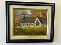Front view of the framed oil painting showing the church image, artist signature, and frame details.