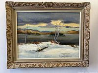 Front view of the oil painting with frame showing winter landscape with water and trees, signed Elizabeth Harold.