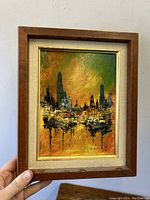 Front view of the framed modernist abstract expressionist painting showing city skyline with tall buildings, vibrant colors and artist signature B Scani.