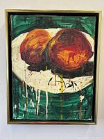 Full front view of the framed encaustic pigment painting depicting two rounded fruits on a white plate against a green background.