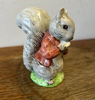Front side view of Timmy Tiptoes Beswick figurine showing the squirrel in reddish jacket and bushy tail.