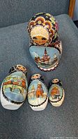 Photo of five vintage nested Matryoshka dolls with detailed painting showing full set and size variation