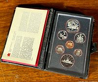 Photo of the open black presentation case containing the 1981 Canada Prestige Double Dollar Mint Set with coins visible inside clear plastic holder.