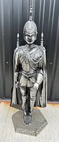 Front view of the decorative medieval knight fireplace suit of armour statue on hexagonal base