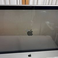 Display screen powered on showing Apple logo during bootup, screen and bezel in good condition
