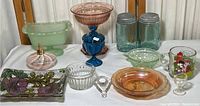 Overview of the assorted colored glass items including bowls, jars, candy dish, and glass tray.