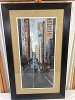 Full view of the framed San Francisco cityscape print with black frame and beige matting.
