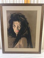 Frontal view of the framed artwork showing the full portrait of the dark-haired woman, the brown frame, and the matting.