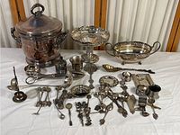 Full collection displayed on a white surface showing all items including large ice bucket, pedestal bowl, large serving dish, and smaller spoons and utensils.