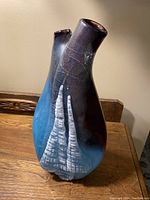 Front view of the mid-century modern art glass vase showing textured design and color variations including dark purple, blue, and white streaks.