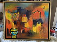 Full-view of the abstract oil painting showing bright orange and yellow dominant colors, geometric shapes, and signature by the artist.