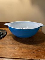 Side angle photo showing the blue exterior and the shape of the mixing bowl with pouring spouts