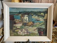 Frontal view of the framed oil painting showing the coastal scene and entire framed artwork.