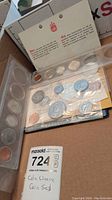 Photo showing multiple sealed uncirculated Canadian coin sets including 1968 dated coins in plastic packaging with informational insert