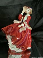 Front view showing detailed flowing red dress and facial features.