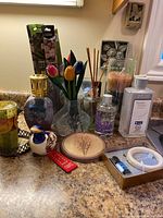 Overall arrangement showing fragrance, pottery, and decor items on countertop